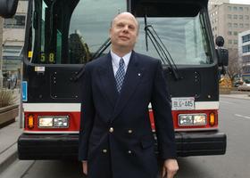 Picture of David Lepofsky standing in front of TTC bus