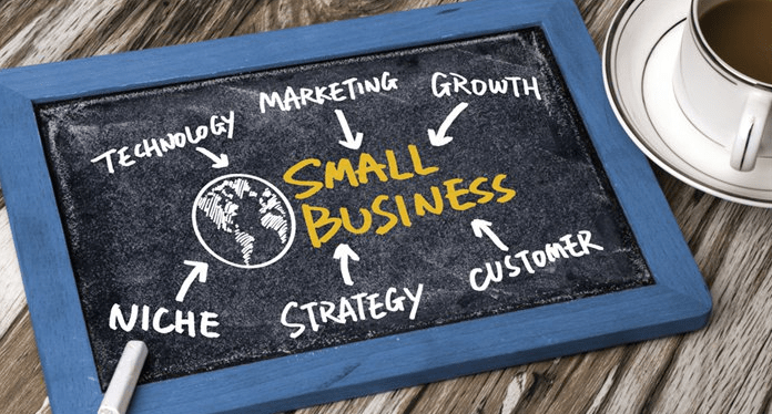 Small Business concept - chalk board with SMALL BUSINESS written middle and technology, marketing, growth, niche, strategy & cutomer all around