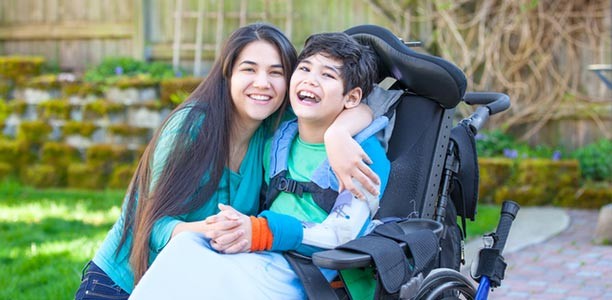 woman embracing child in a wheelchair