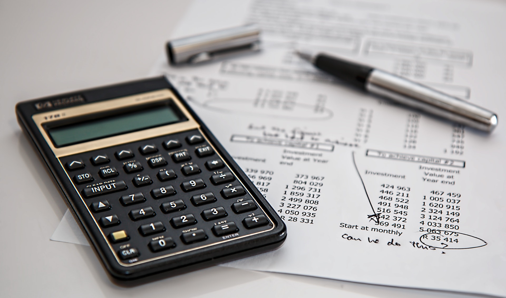 Calculator and balance sheet from accounting with words can we do this due to financial toll.