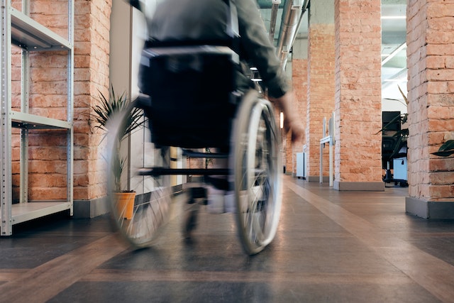 an employee using the wheelchair in the office walkway