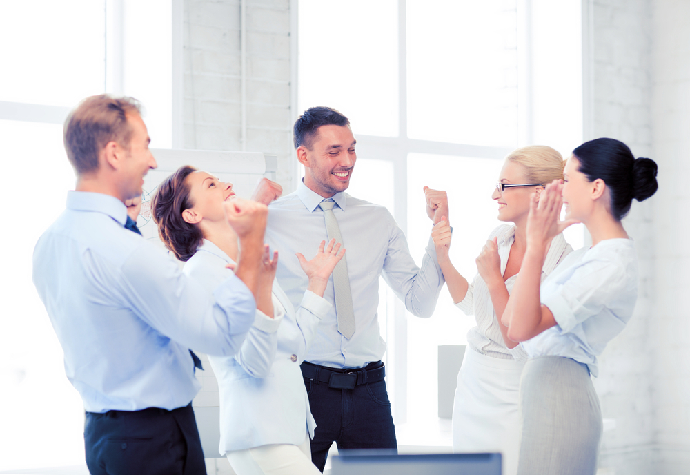 business team celebrating victory in office