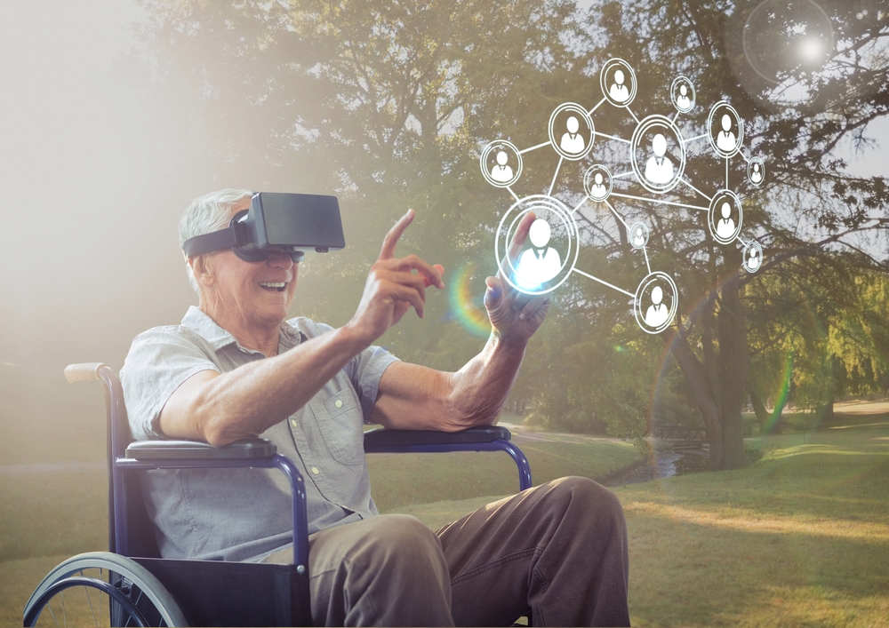 An elderly man sitting on a wheelchair using a VR Goggles